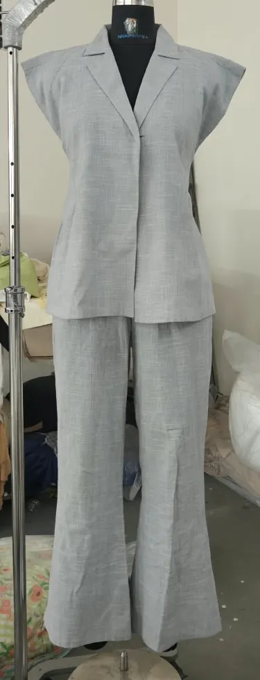 Grey linen-look sleeveless notch-collar top and flared trousers on a dress form, front