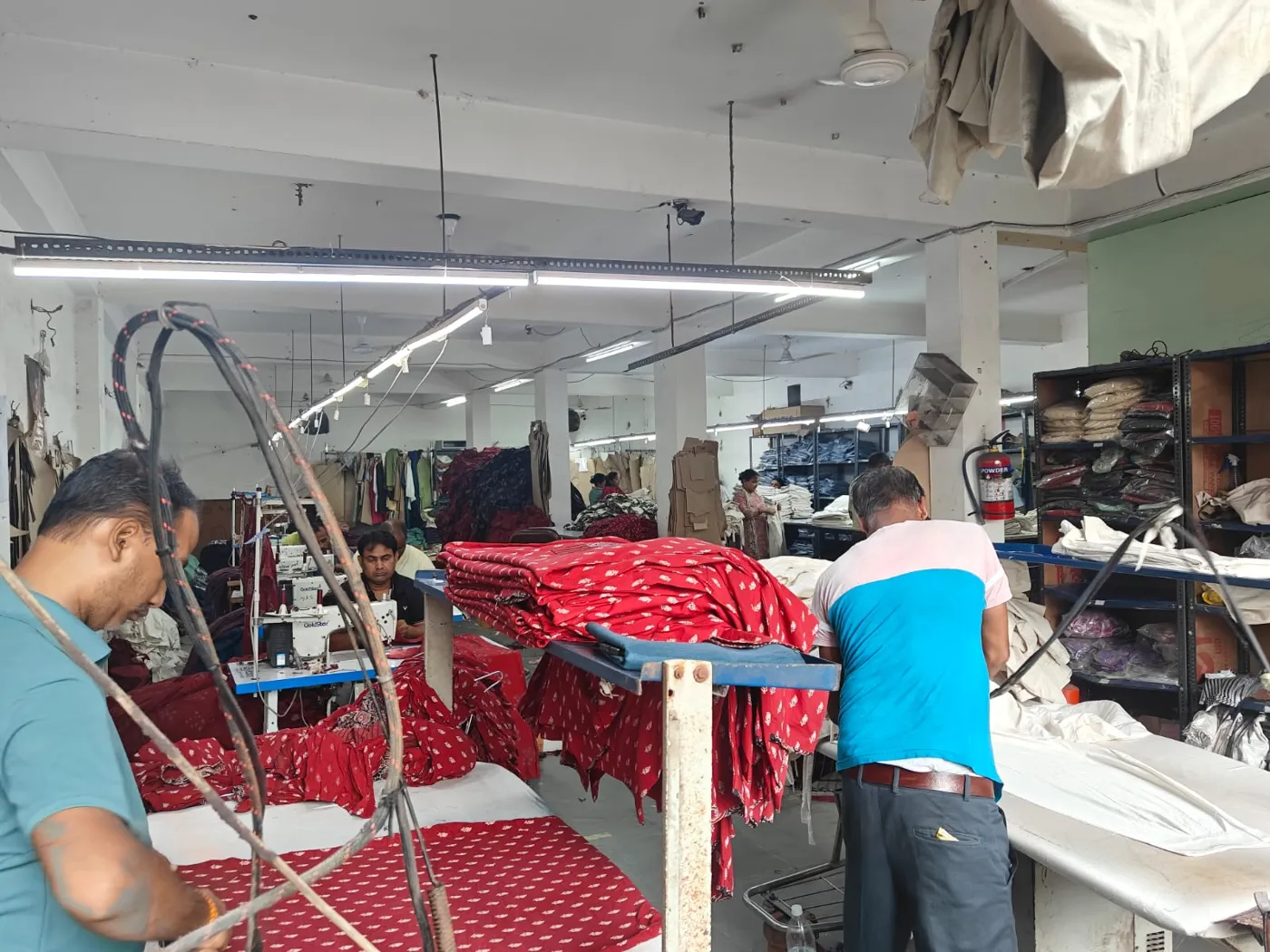 Finishing and pressing tables with garments being checked in the factory