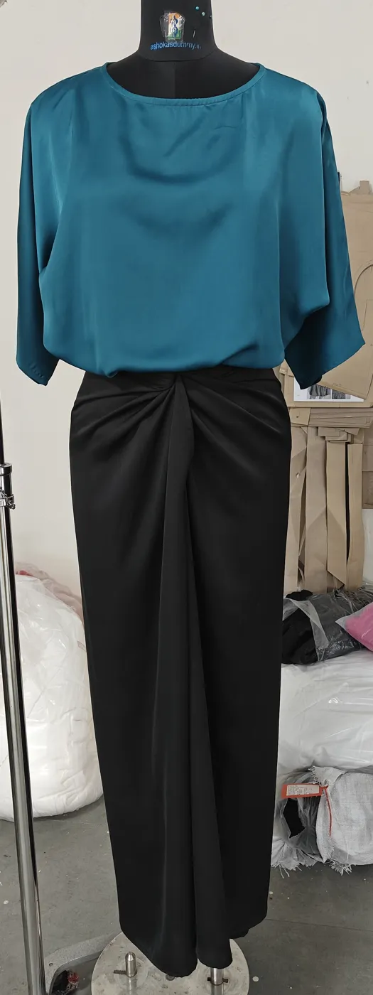 Black satin midi skirt with twisted knot detail at the front waist on a dress form