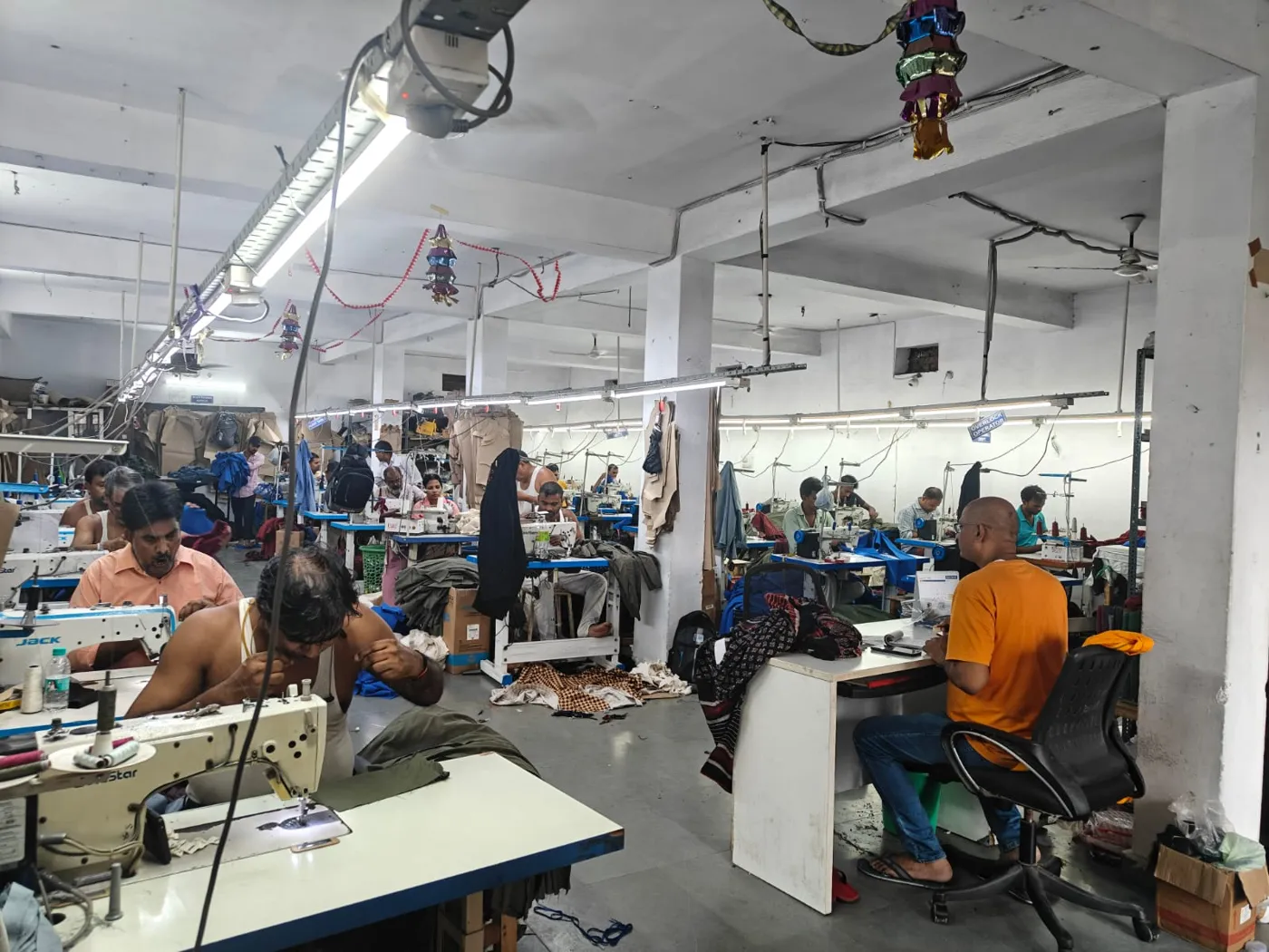 Garment stitching floor with operators at single-needle machines in Kapashera, New Delhi